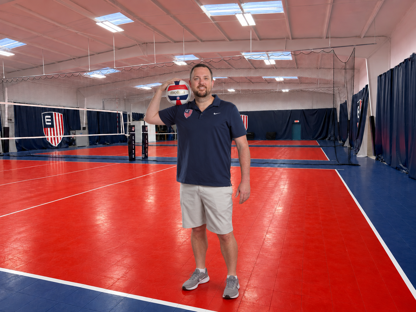 Coach standing on the courts at the Elite Volleyball home gym in Sarasota